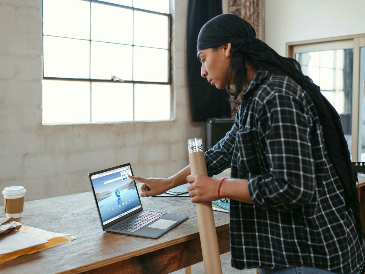 a person sitting at a table with a laptop