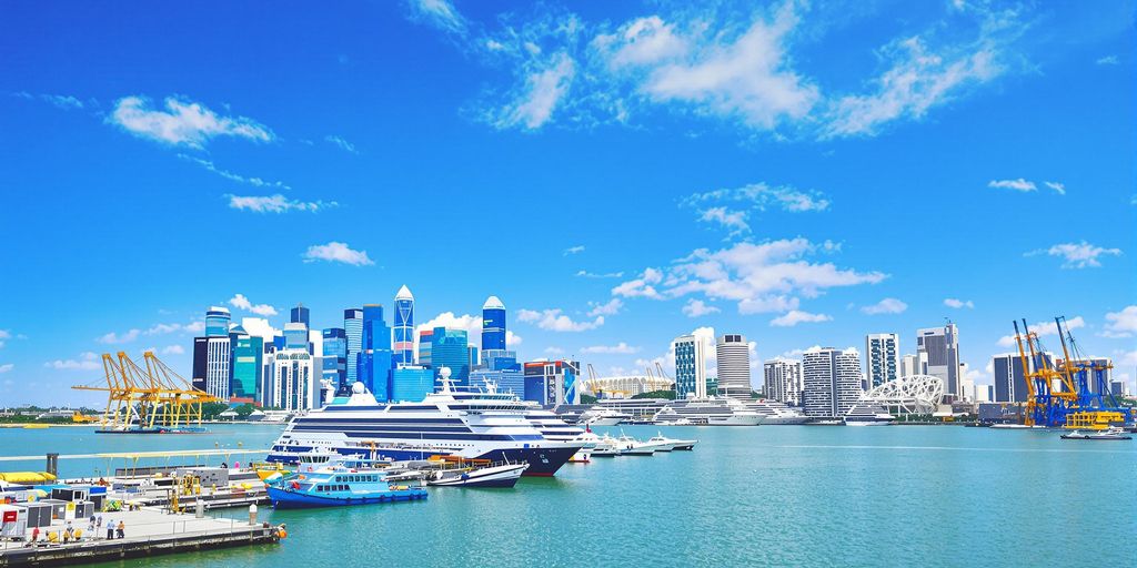 Singapore harbor with modern ships and skyline.