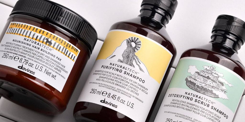 Three bottles of hair care products on a white background.