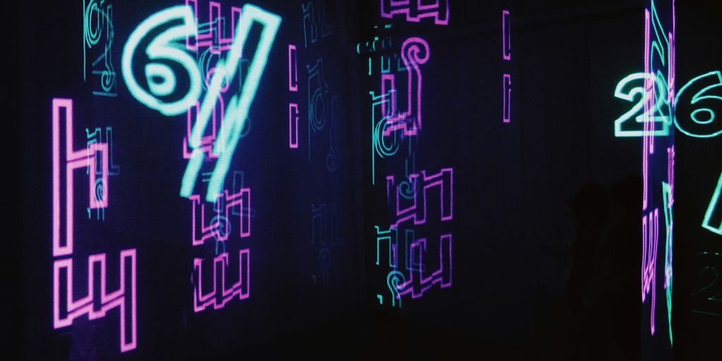 neon signs are lit up in a dark room