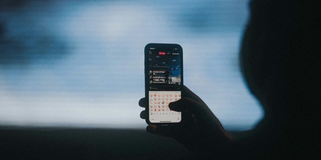 person holding black iphone 4