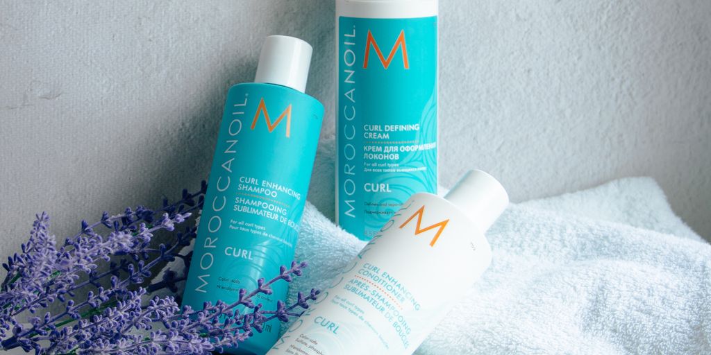 Haircare products with lavender on a textured background.