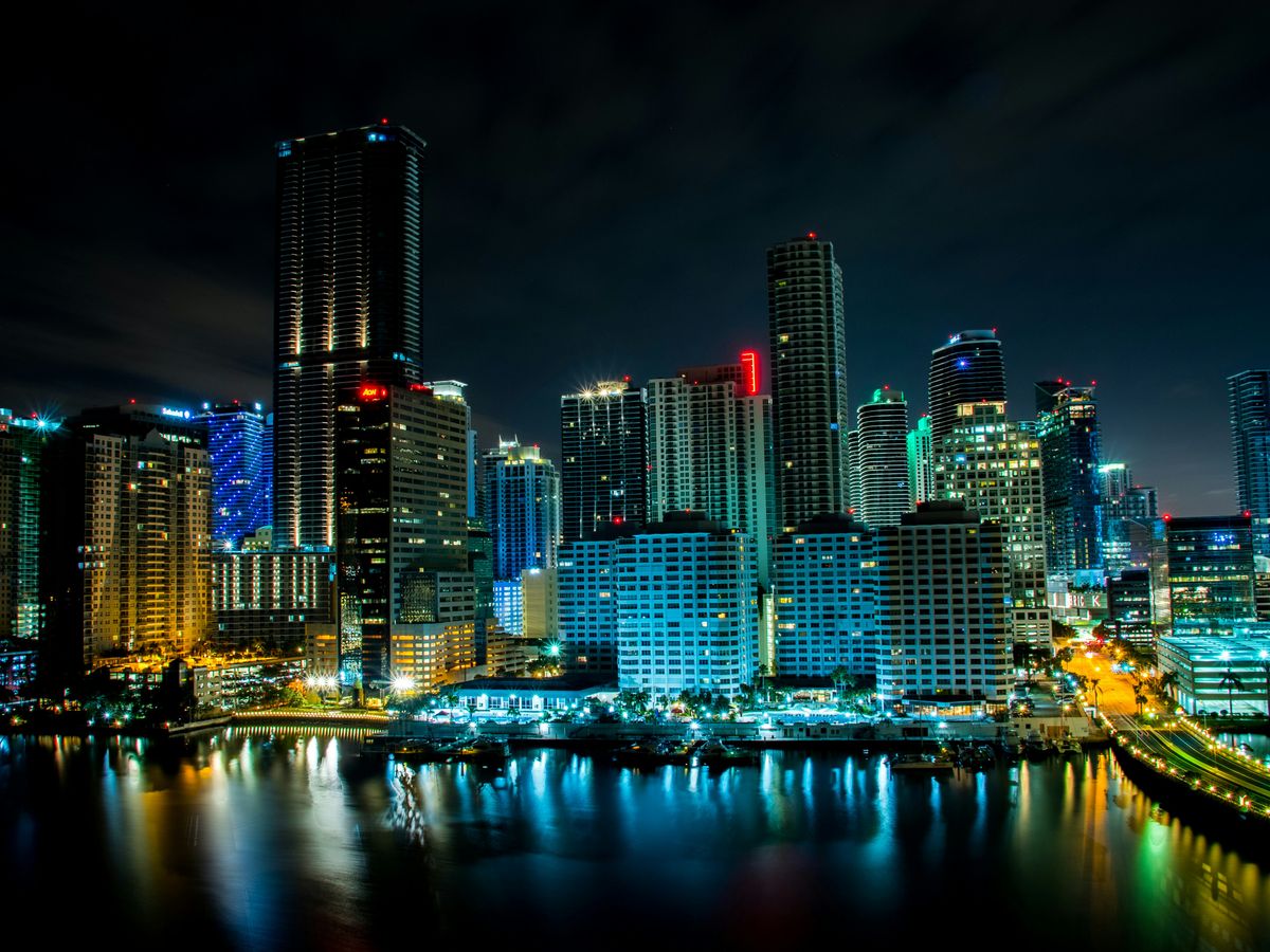 lighted building near body of water at nighttime