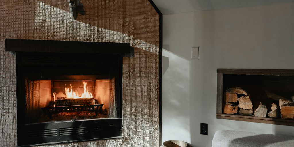 a living room with a fire place and a chair