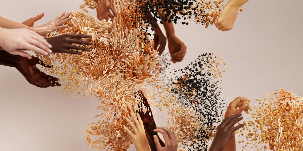 a group of hands reaching up into a pile of food