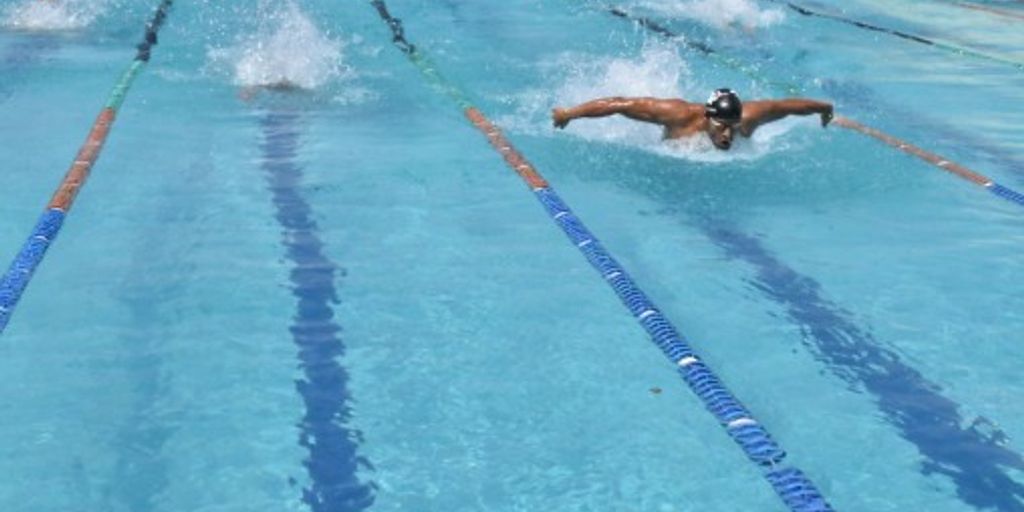 swimmer drinking recovery protein shake poolside