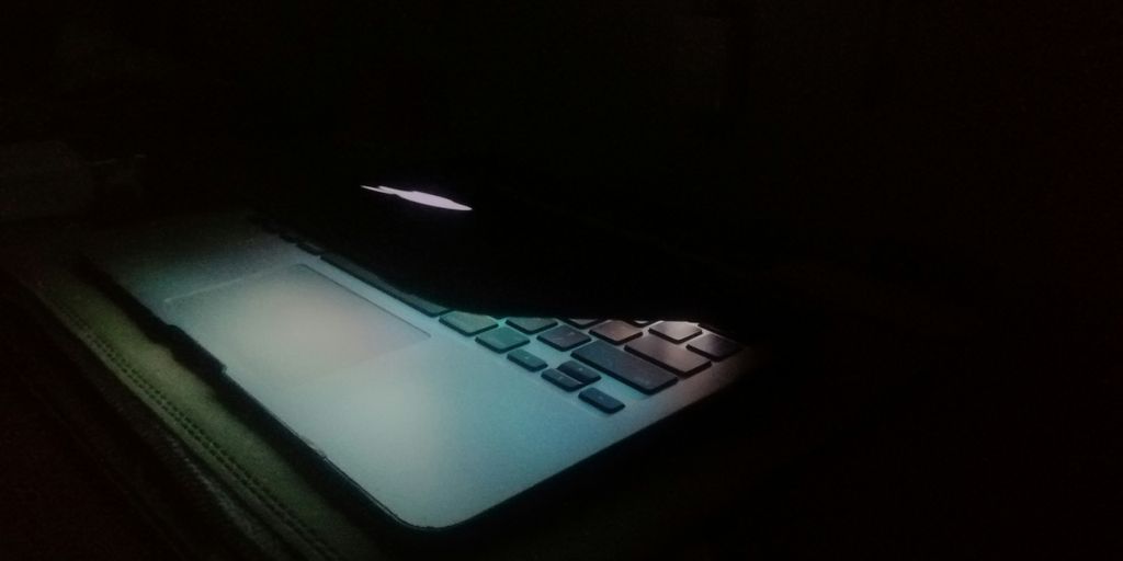 a laptop computer lit up in the dark