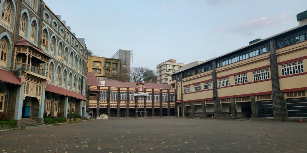 an empty parking lot in front of a row of buildings