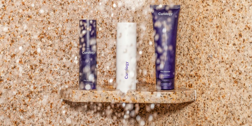 three assorted toiletries on brown shelf