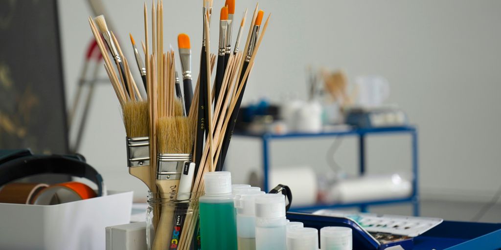 a group of pens and pencils on a desk