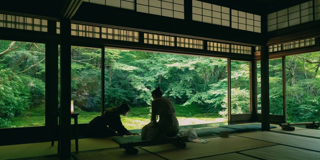 a couple of people sitting on top of a wooden floor