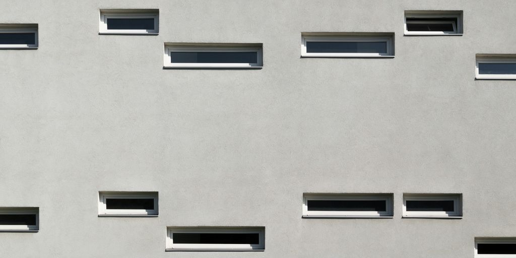 a building with several windows and a clock