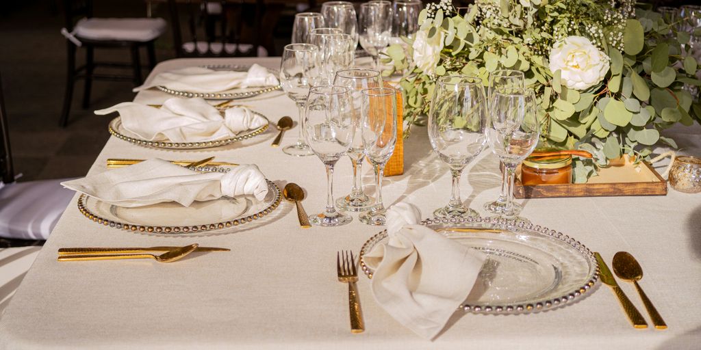 Elegant wedding table setting with flowers and glassware.
