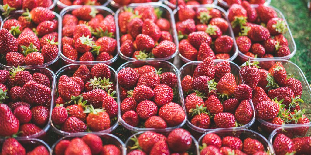 red strawberries in clear plastic container
