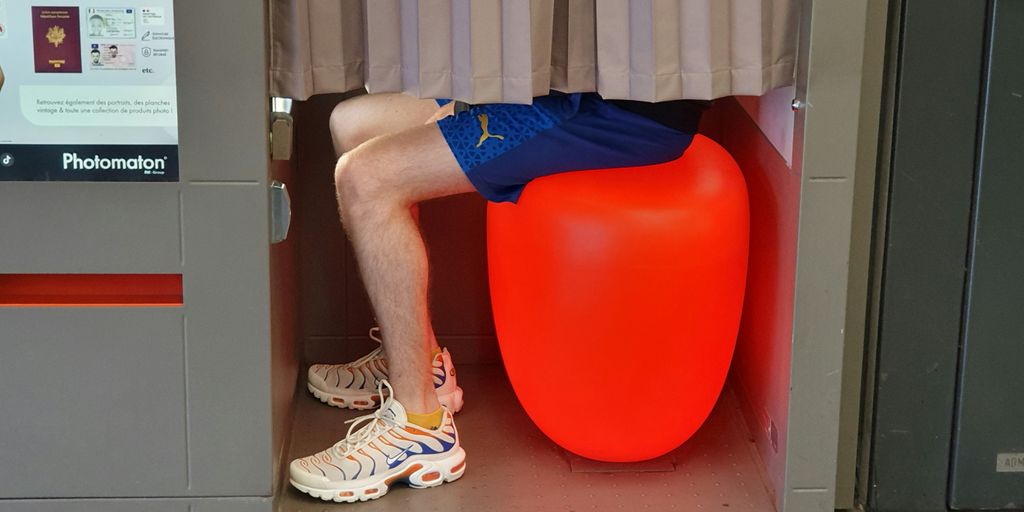 A person sitting on a large orange object