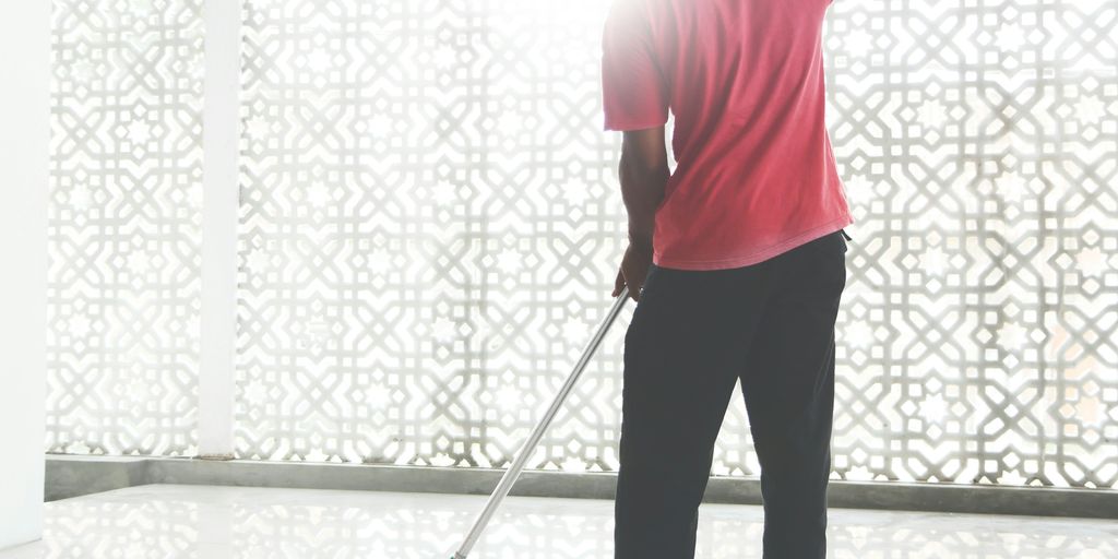 a person with a broom and a bucket
