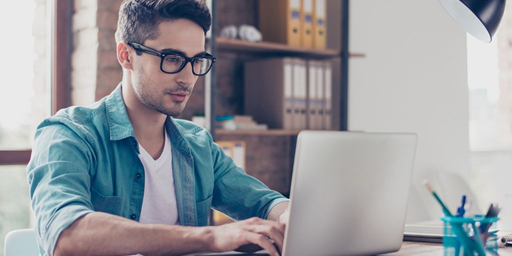 person typing on a laptop with email interface, personalized assistant, modern office