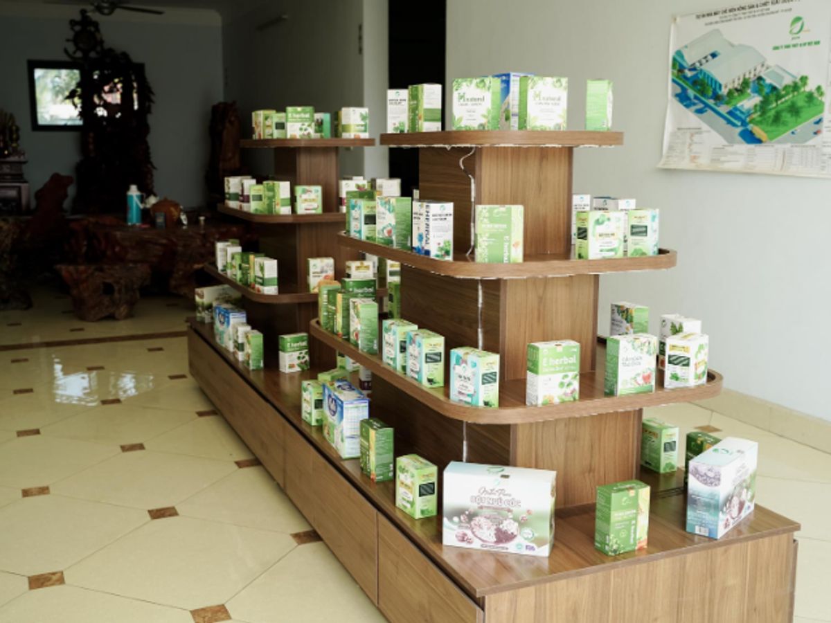 Display of various packaged products on wooden shelves.