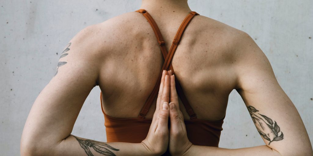 a woman in a bra top is doing yoga