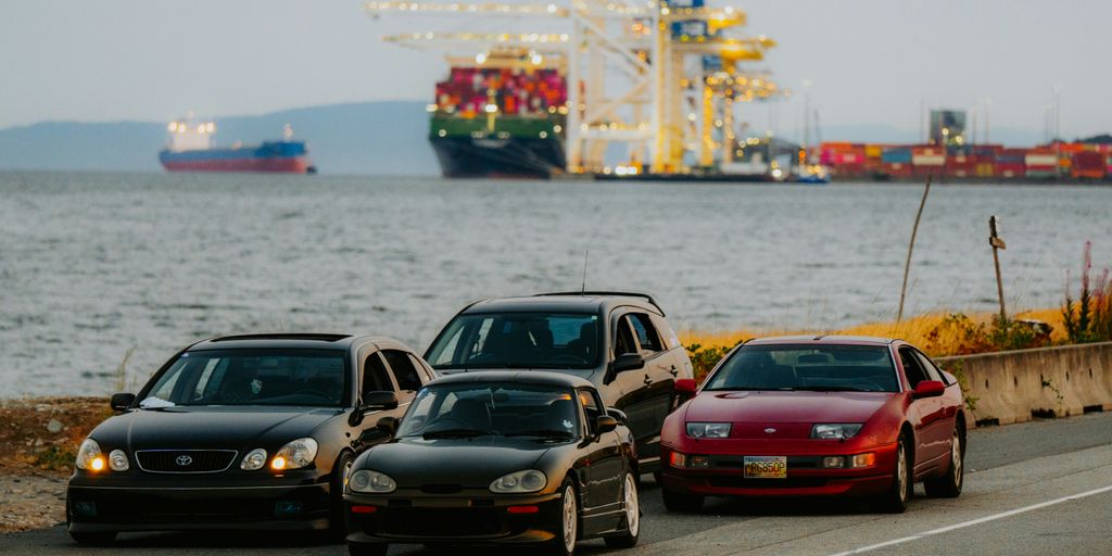A group of cars parked on the side of the road