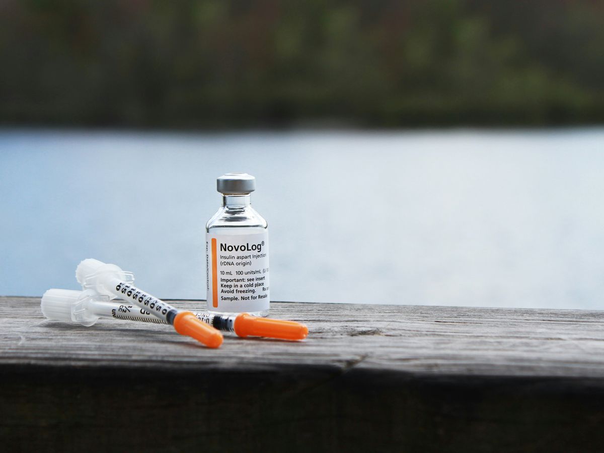 orange and white plastic bottle on brown wooden table