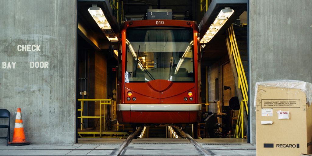 red train in between gray concrete wall