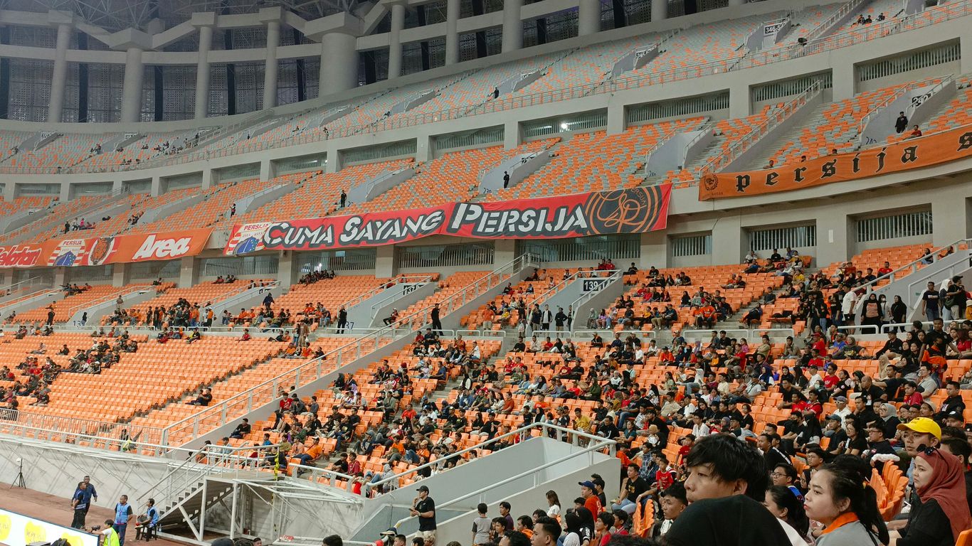a large crowd of people sitting in a stadium