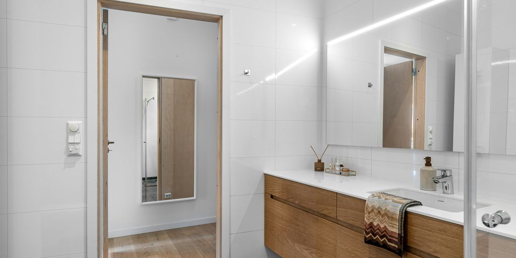 A bathroom with a large mirror and a sink