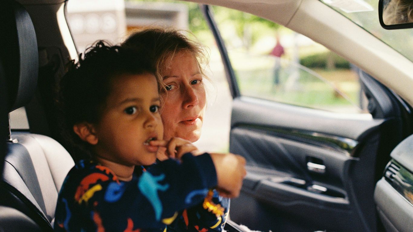 a person and a child in a car