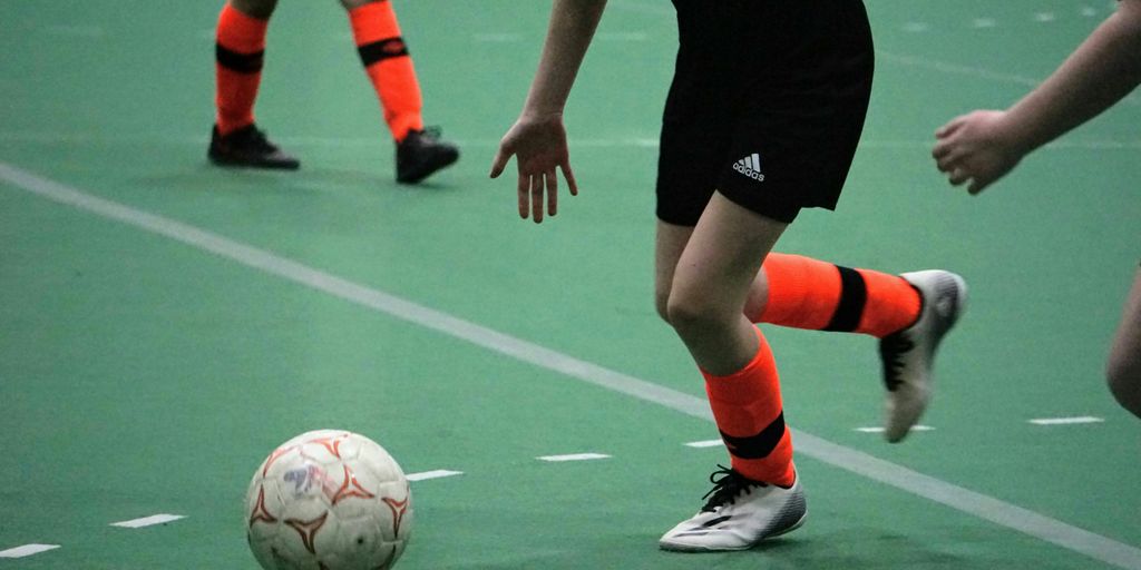 a group of young people playing a game of soccer