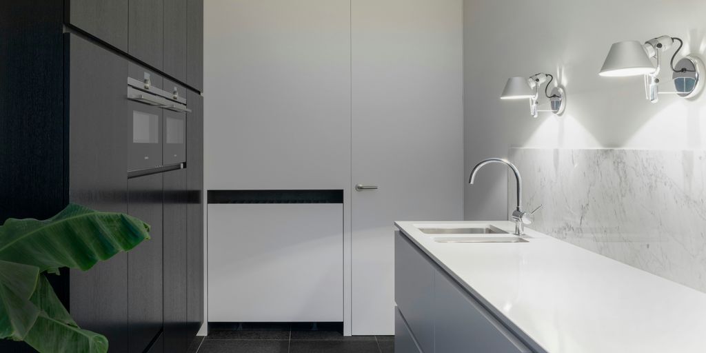 white stainless steel sink with faucet beside closed door