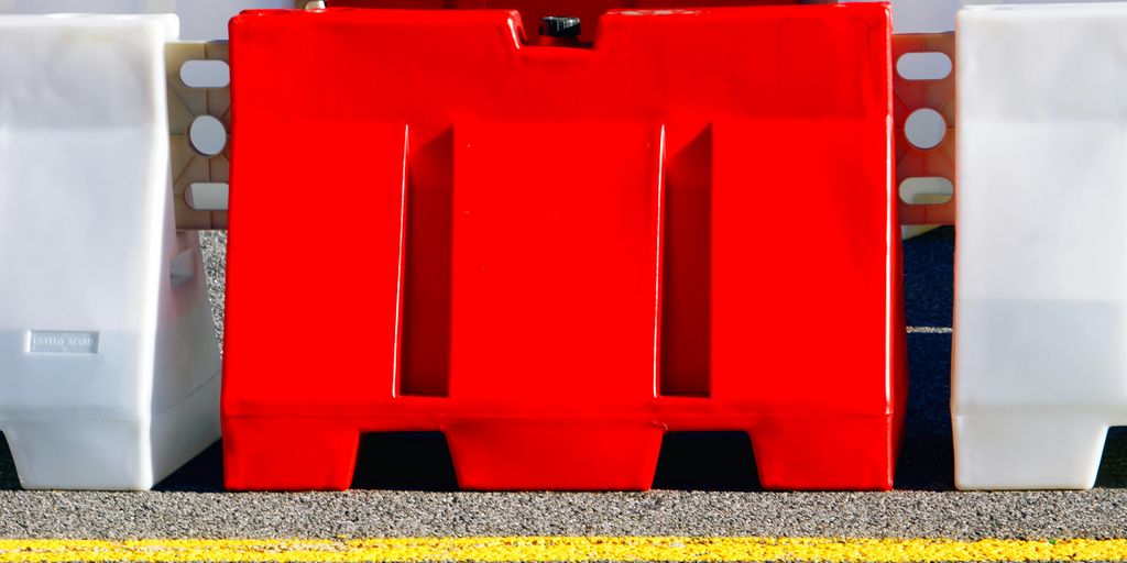A red and white fire hydrant sitting on the side of a road