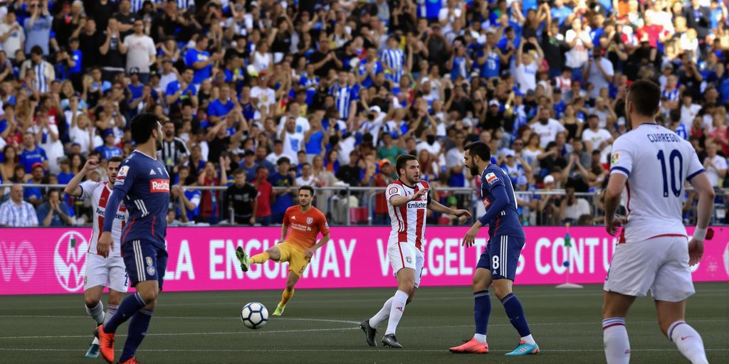 Real Sociedad players in blue and white during a match.