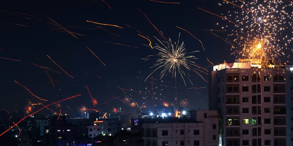 fireworks are lit up in the night sky above a city