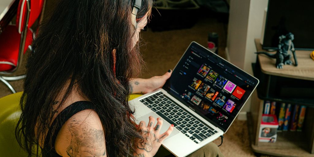 a woman sitting in a chair with a laptop