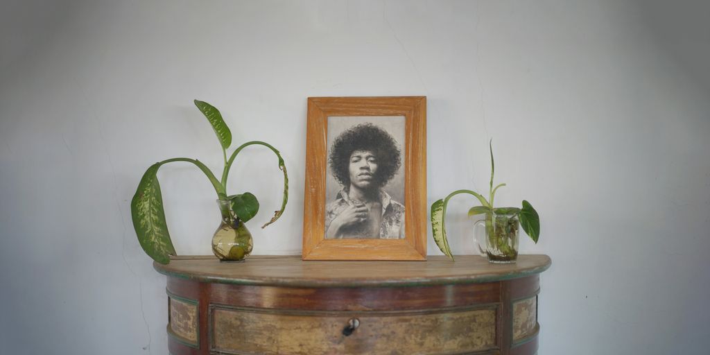 a picture of a man with a afro is on a dresser