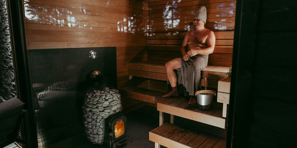 a man sitting in a wooden sauna