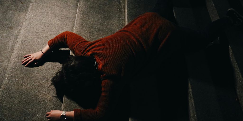 woman lying on stairway at nighttime