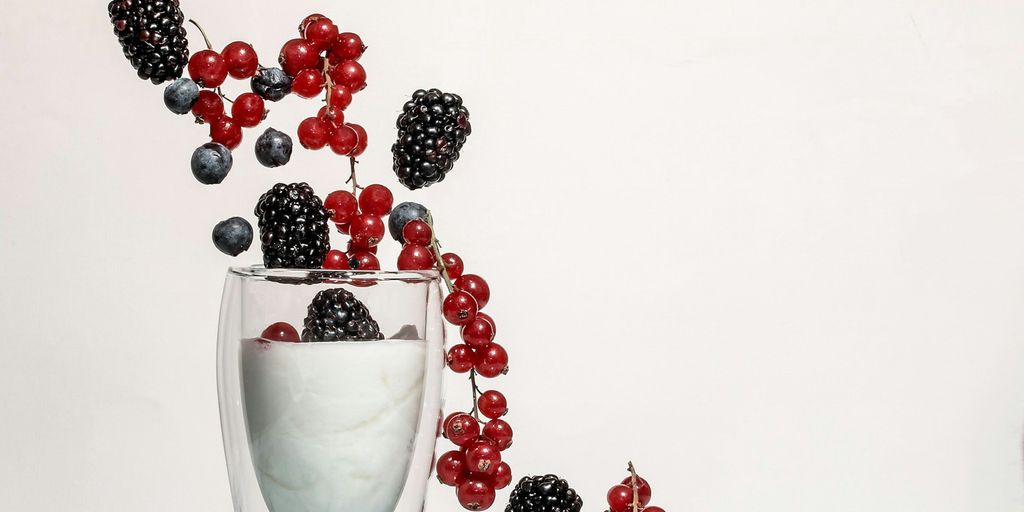 red and black berries on clear glass cup