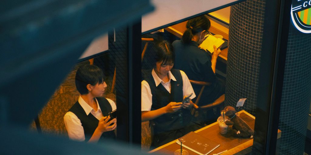 a group of young people sitting next to each other
