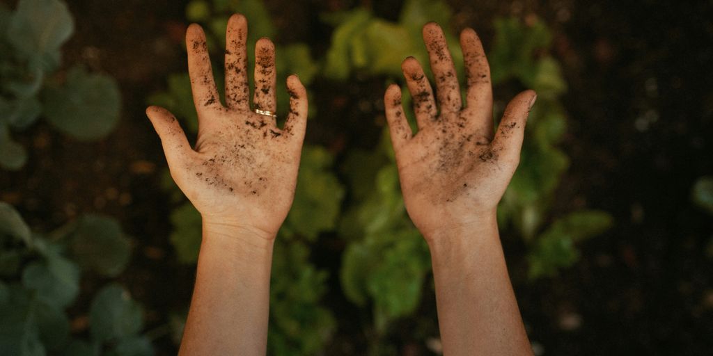 persons left hand with green nail polish