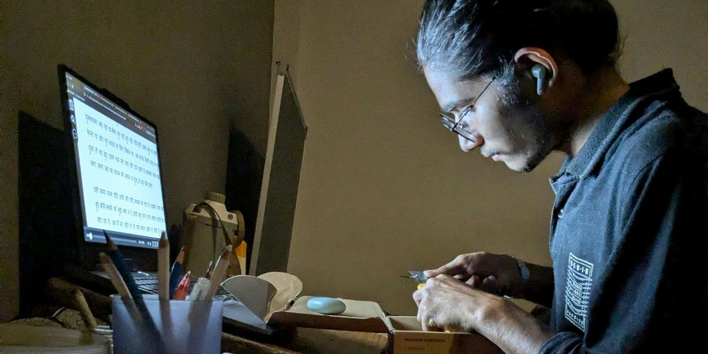 A woman sitting at a desk working on a computer