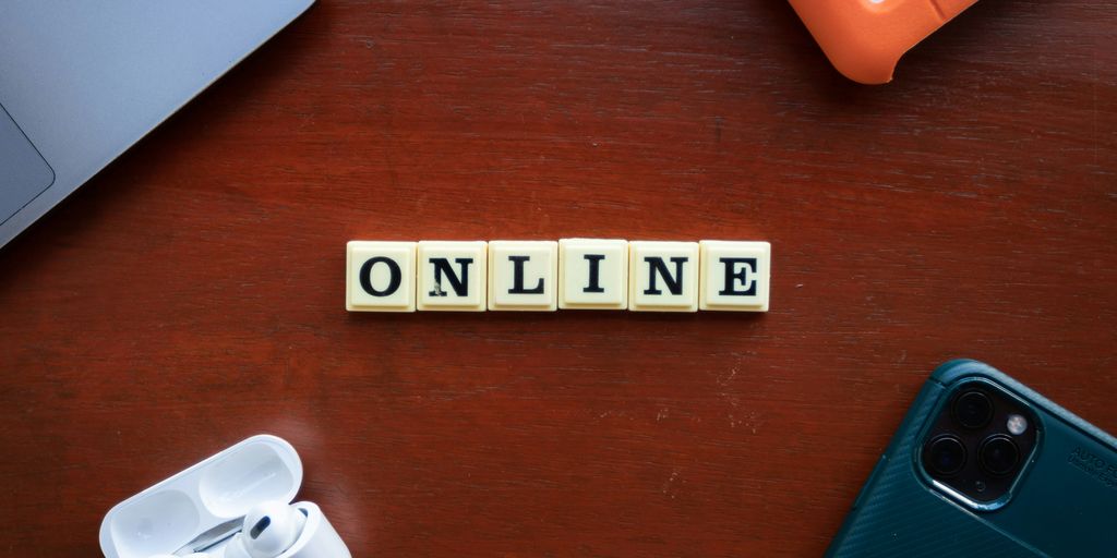 the word online spelled with scrabble letters on a wooden table
