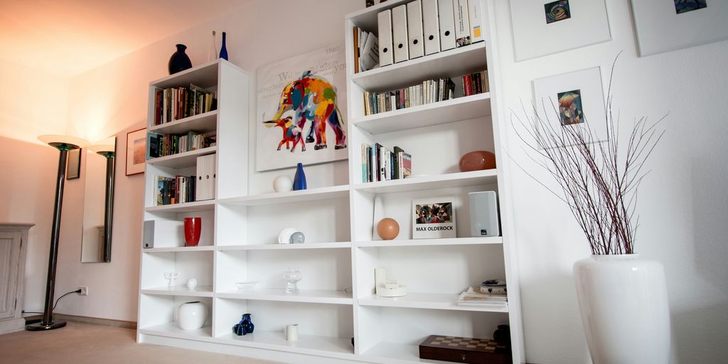 white wooden shelf with books