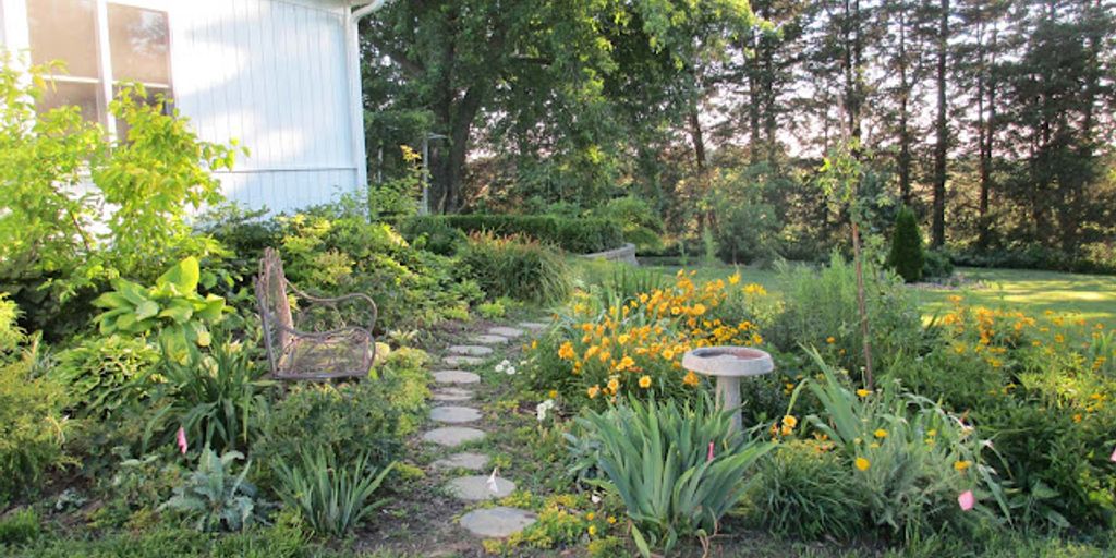 garden with birdhouses, bee hotels, and butterfly-friendly plants