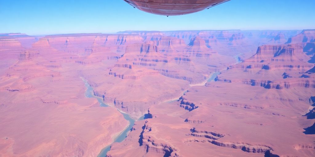An airplane flies high above the vast Grand Canyon.