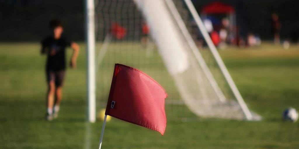 a red umbrella on a football field