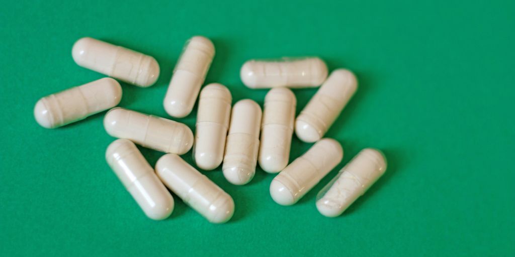 A pile of pills sitting on top of a green table