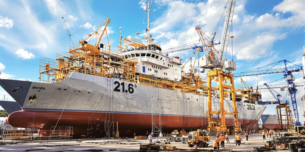 Shipyard in Brazil with ships and workers in action.