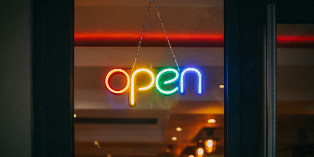red and white open neon signage